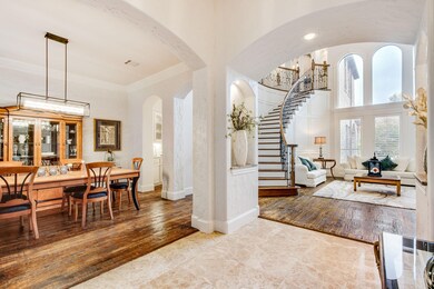 Enter to this architecturally pleasing open floor plan.  The curved staircase and floor to ceiling windows are sure to delight and impress.