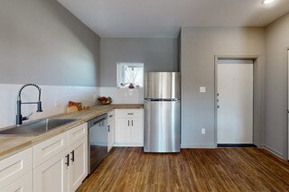 Kitchen with stainless steel appliances, white cab