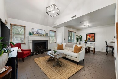 Living area featuring a chandelier, high vaulted 