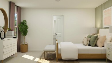 Bedroom with baseboards, carpet flooring, and ensu