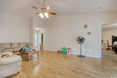 Living room featuring high vaulted ceiling, light 