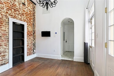 Soaring ceilings and wrought-iron spiral staircase add architectural charm and vertical space.