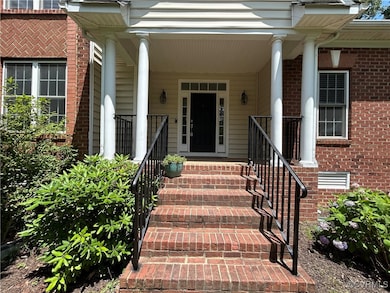 Property entrance featuring brick siding and a por