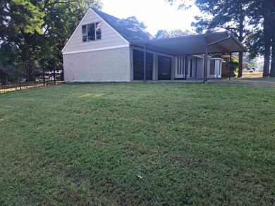 View of side of home with a lawn