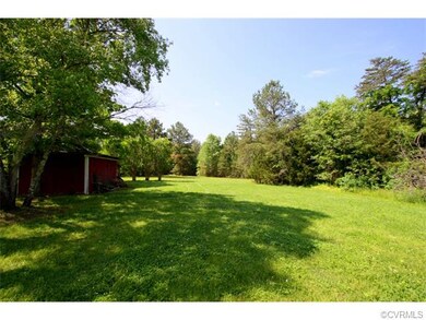 Large open land that leads into more wooded area t