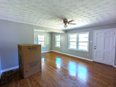 Empty room with a textured ceiling, wood finished 