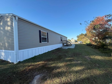 View of property exterior with a lawn