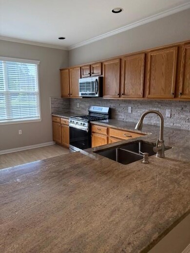 Kitchen featuring gas range, decorative backsplas