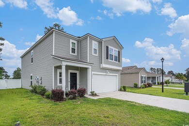 Traditional-style home with a garage and concrete 