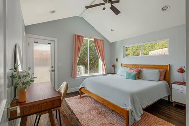 Bedroom with beam ceiling, access to outside, cei