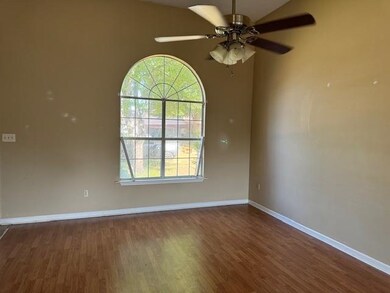 Empty room featuring ceiling fan and dark wood-typ