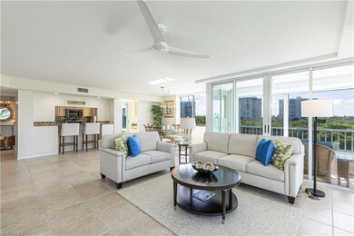 Tiled living room featuring ceiling fan and expansive windows