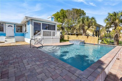 View of swimming pool with a sunroom, an in-ground hot tub, and a patio