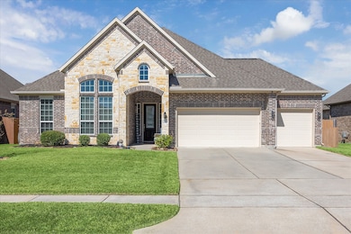 This home offers 4 bedrooms, 2.5 baths, a three-car garage with ample storage, large arched windows, a manicured lawn, and a welcoming entry—ideal living.