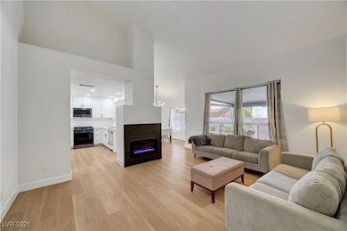 Living room featuring light wood-style floors, a h