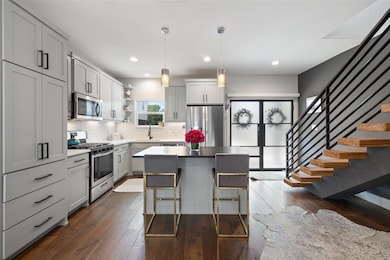 Kitchen featuring a sink, open shelves, stainless