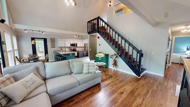 Living room with visible vents, baseboards, wood f