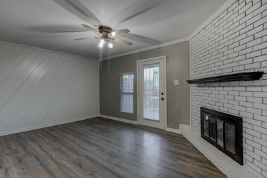 Unfurnished living room featuring ceiling fan, a f