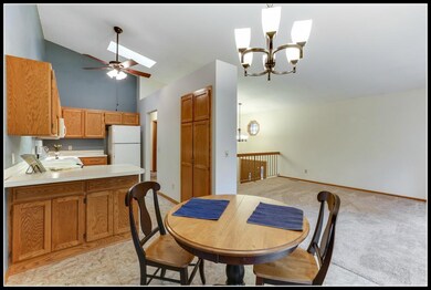 Kitchen features vaulted ceiling with skylight and