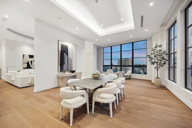 This photo captures the seamless flow of the living areas, highlighting the open concept design that defines this home. The spacious dining room flows into the inviting living room, emphasizing the interconnected layout that is perfect for both casual living and sophisticated entertaining.

