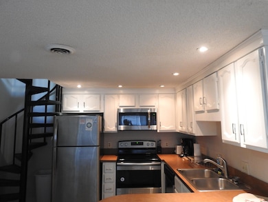 Kitchen featuring stainless steel appliances, whit