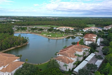 Aerial view of residential area with a nearby body of water and a heavily wooded area