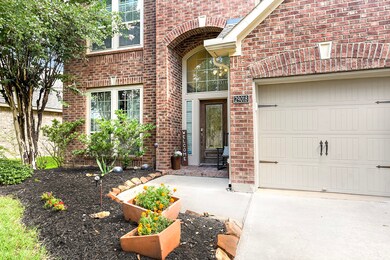 Inviting sidewalks and flower beds lead up to the front porch.