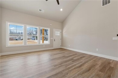 Spare room featuring a ceiling fan, high vaulted ceiling, light wood-type flooring, baseboards, and recessed lighting