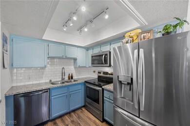 Kitchen featuring stainless steel appliances, a si