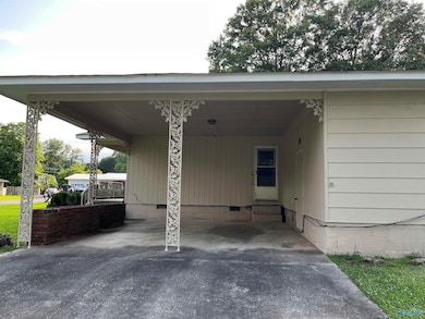 Two car carport on front on home with large storage room