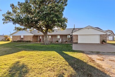 Single story home featuring a garage and a front y