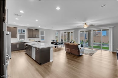 Kitchen with dishwasher, a sink, open floor plan,
