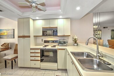 Kitchen featuring sink, a raised ceiling, white ra