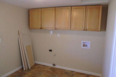 Inside laundry with cabinets