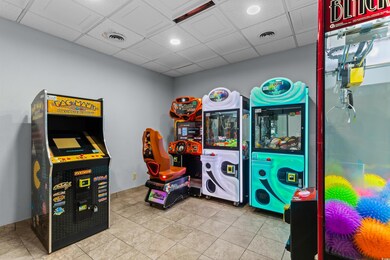 Game room featuring a paneled ceiling and tile pat