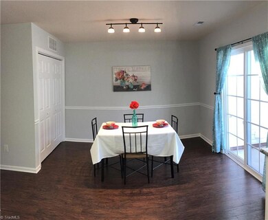 The large dinning room is ready for your large dinning room table. On the left is the inside laundry connection and to the right is the sliding back door. The wonderful laminate floor brings the whole first floor together.