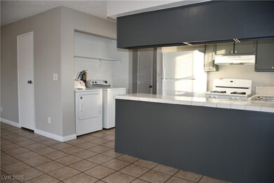 Kitchen tile counters, washer and dryer, and light