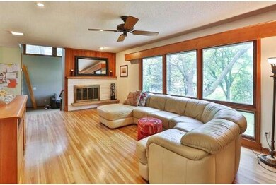 Floor to ceiling windows overlook beautiful pond v