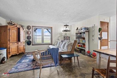 Living room featuring concrete flooring and a text
