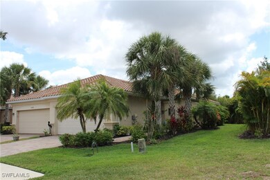 View of side of property with a tile roof, a garag
