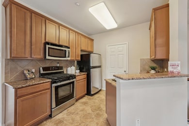 Kitchen with stainless steel appliances, a penins