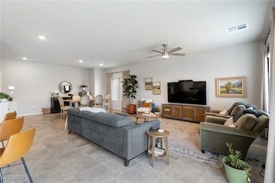 Living room with recessed lighting, ceiling fan, a