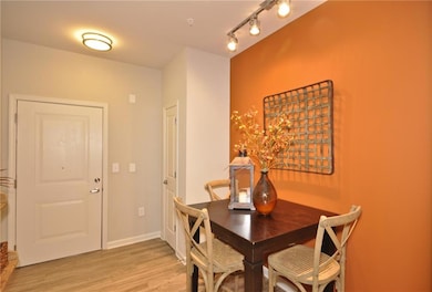 Dining area with light hardwood / wood-style floor