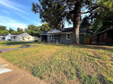 Ranch-style home with a front yard and brick siding