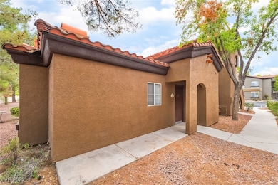 View of side of home featuring a tiled roof and st