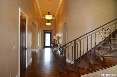 Gorgeous hand-scraped hardwood floors greet you as