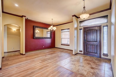 Entrance foyer and dining room with crown molding,