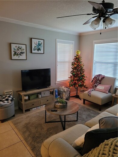 Living room with crown molding, plenty of natural