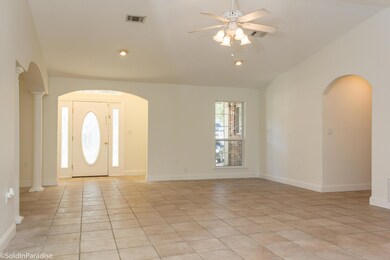 Spacious living area with tile flooring.