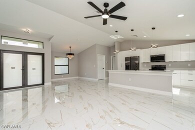 Unfurnished living room with vaulted ceiling, ligh